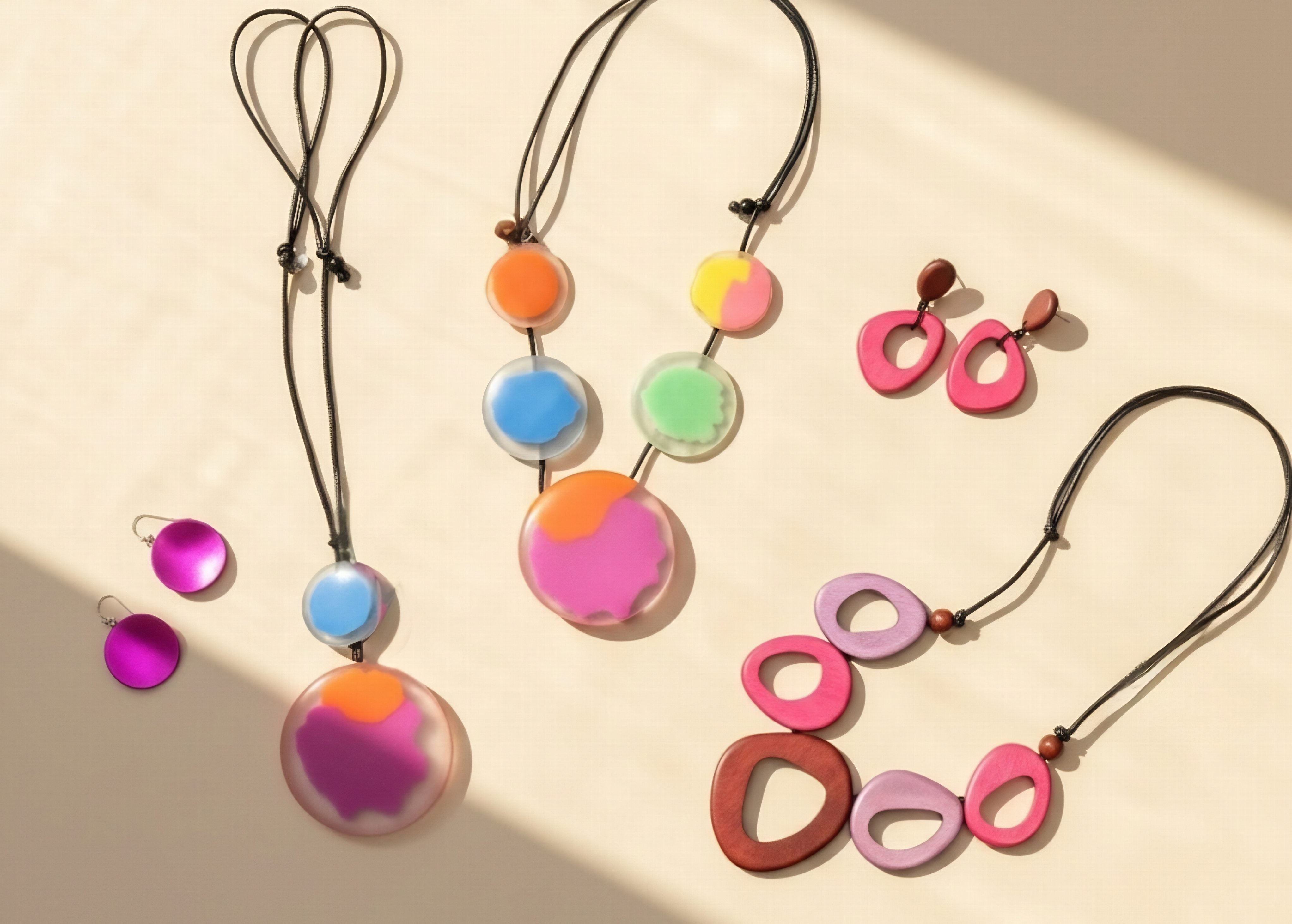Colorful necklace and earrings on a beige background