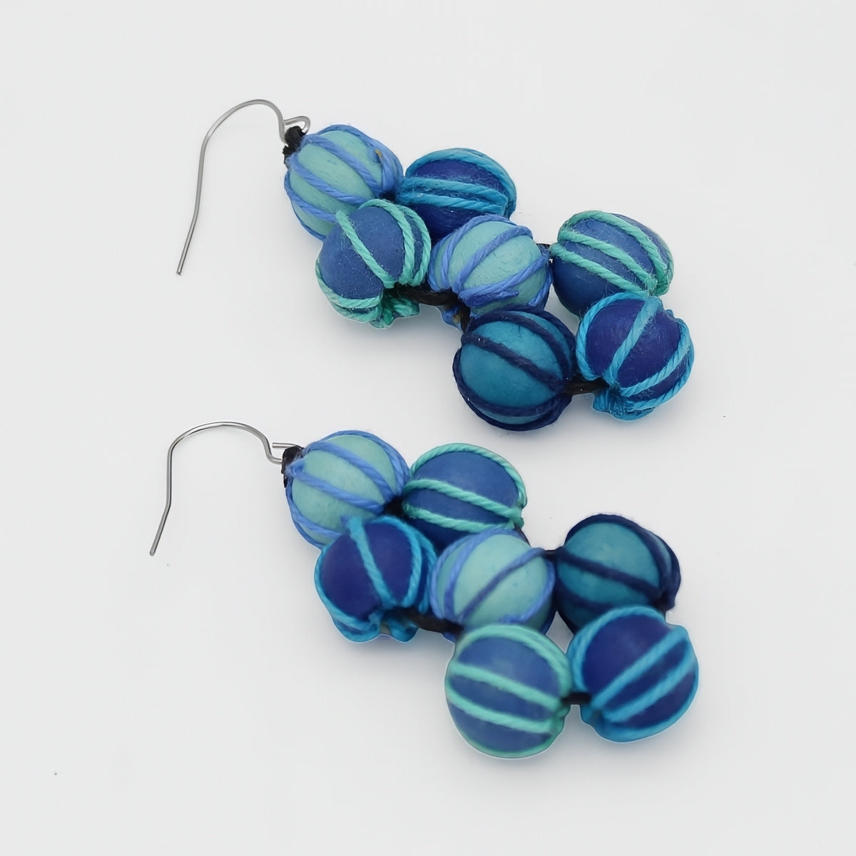Pair of blue beaded earrings on a white background