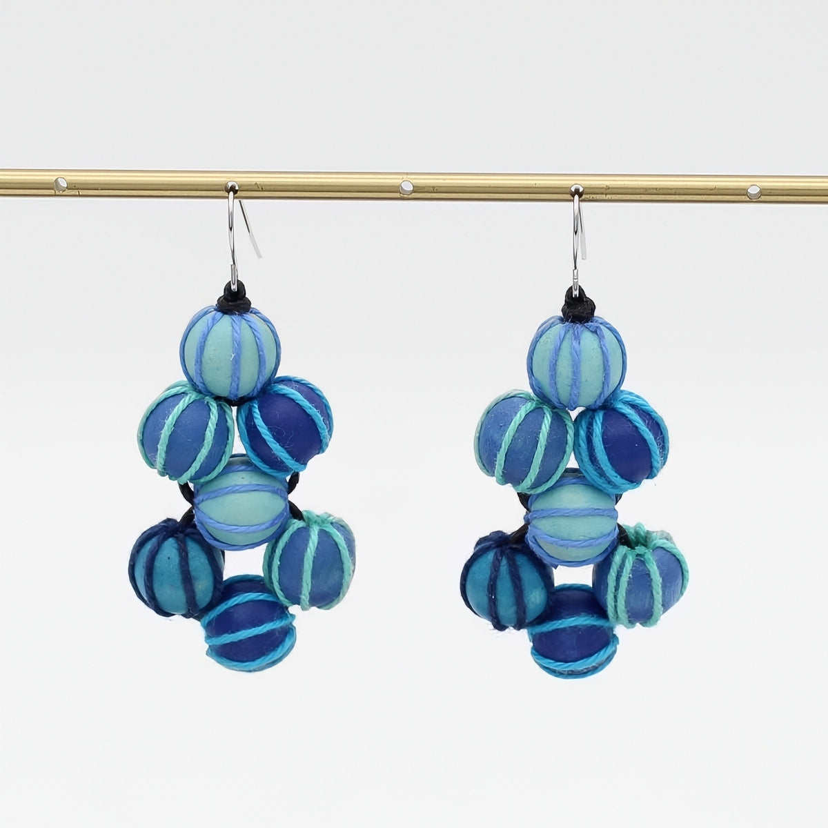 Blue and aqua beaded earrings on a white background