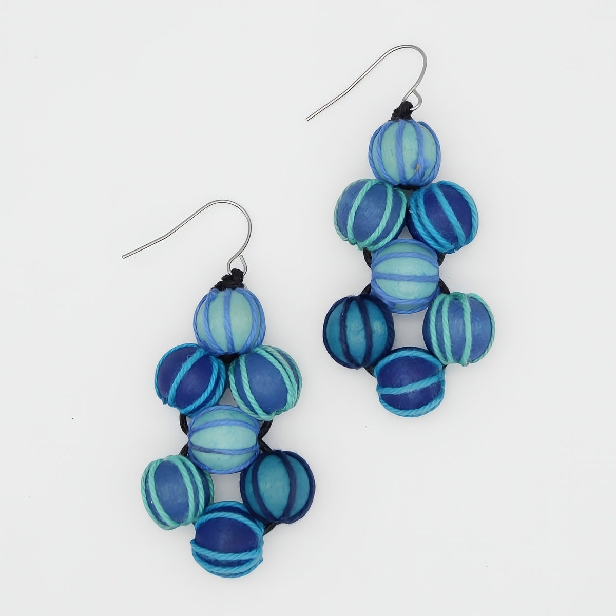 Blue and turquoise beaded earrings on a white background
