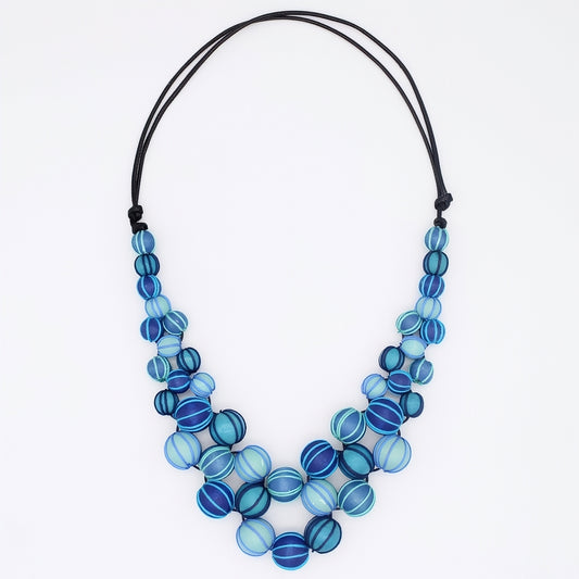 Necklace with blue and aqua beads on a white background
