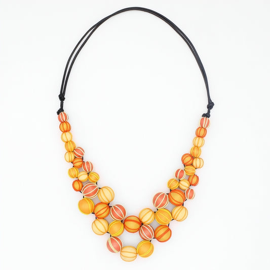 Necklace with orange and yellow beaded design on a white background