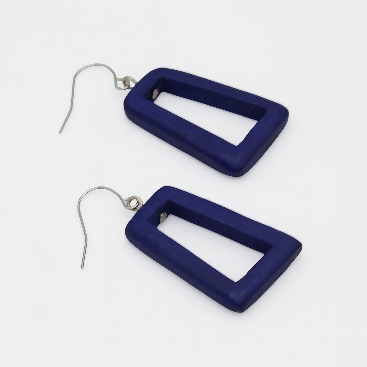 Navy blue rectangular earrings on a white background