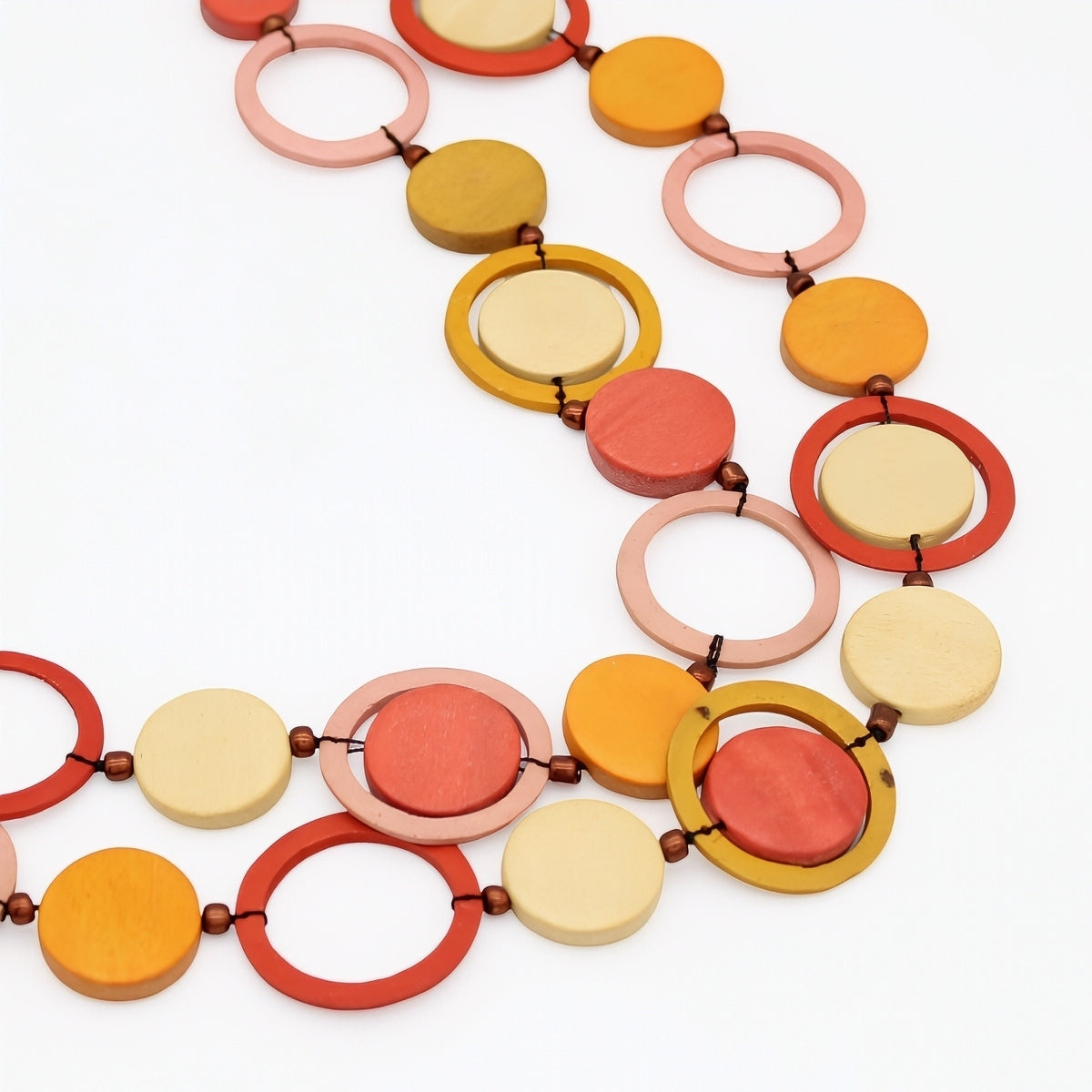 Colorful necklace with circular and ring-shaped beads on a white background