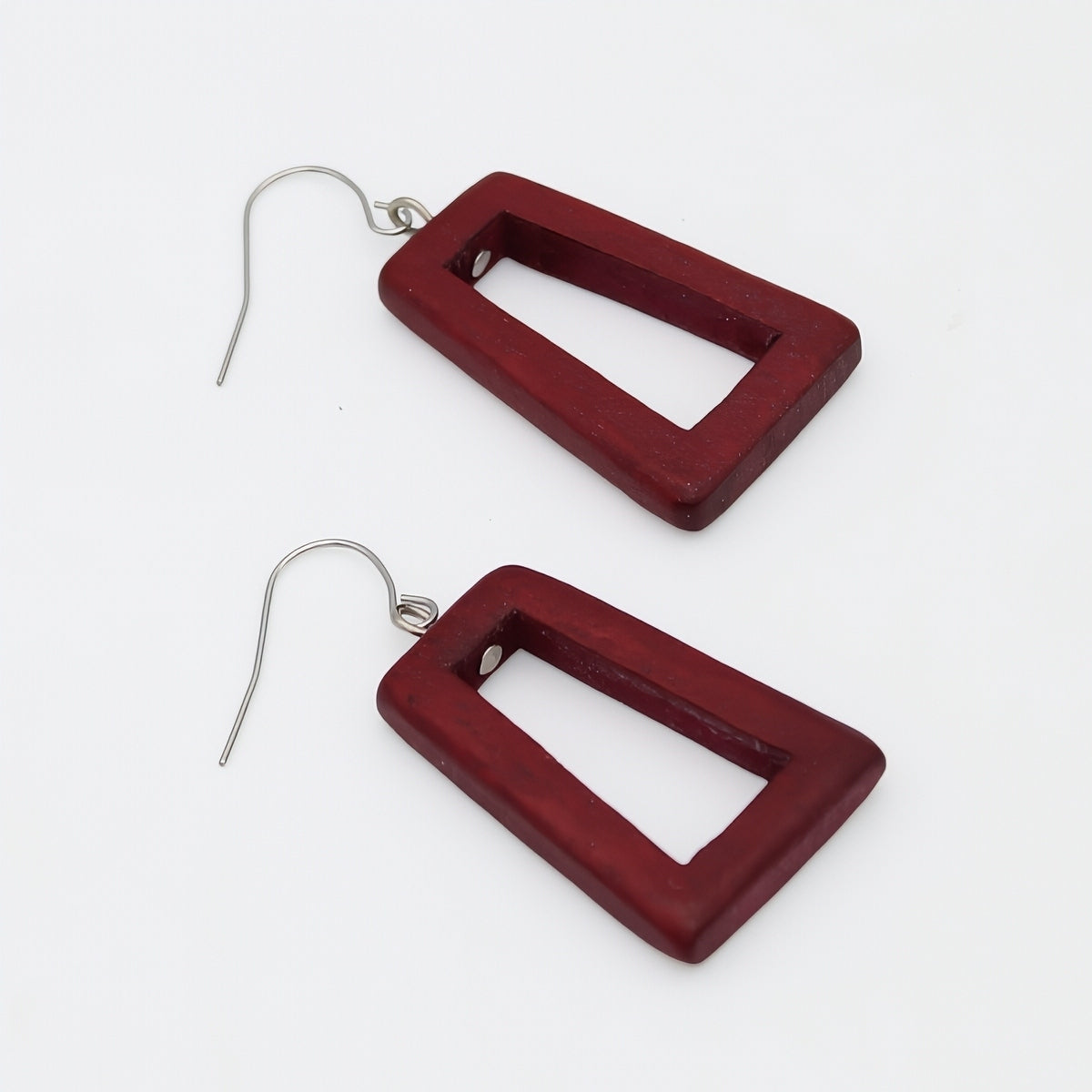 Red square earrings on a white background
