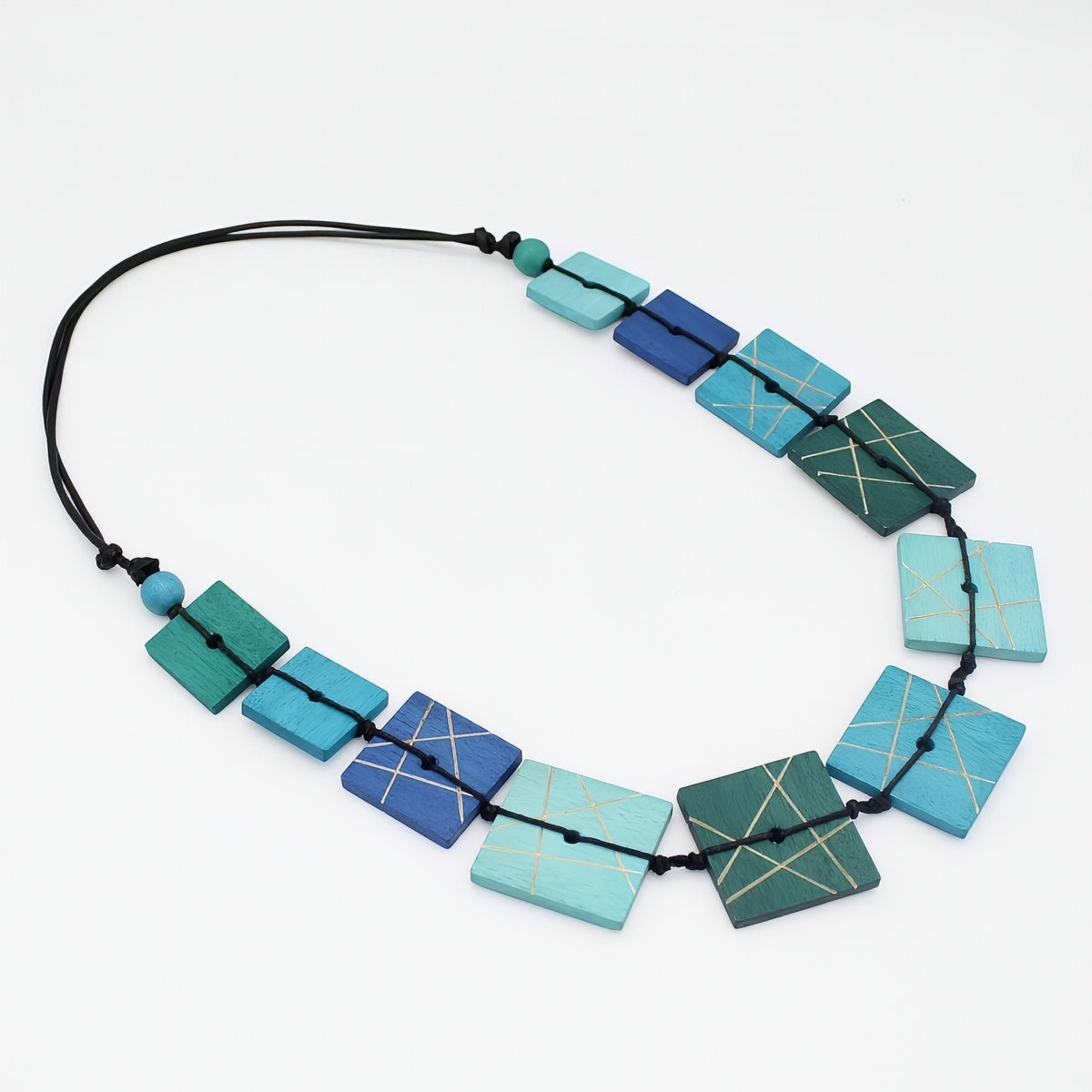 Necklace with geometrically patterned blue and green beads on a white background