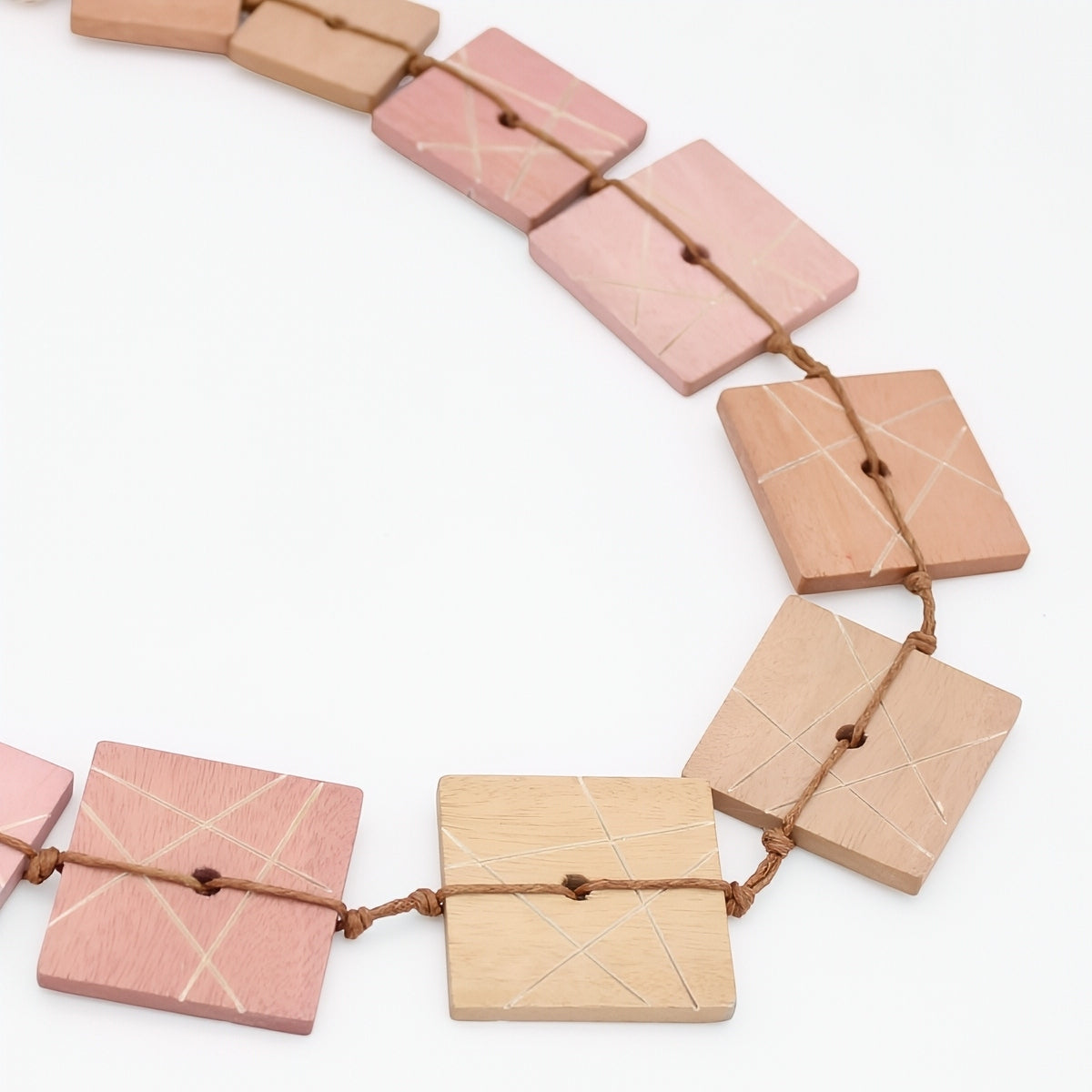 Necklace with square wooden beads on a white background
