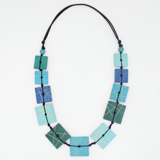 Necklace with geometrically patterned blue and green beads on a white background