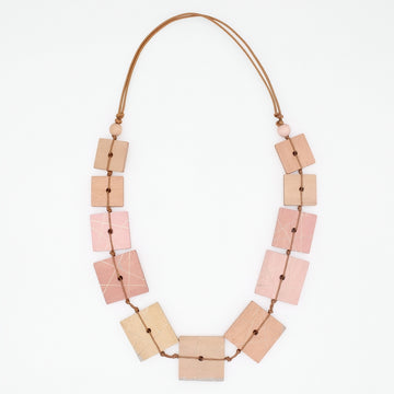 Necklace with square-shaped beads in pink, beige, and brown on a white background