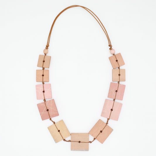 Necklace with square-shaped beads in pink, beige, and brown on a white background