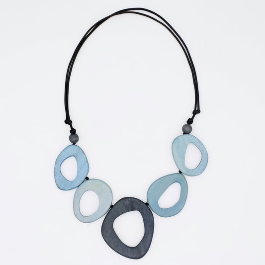 Necklace with blue and black oval-shaped beads on a white background