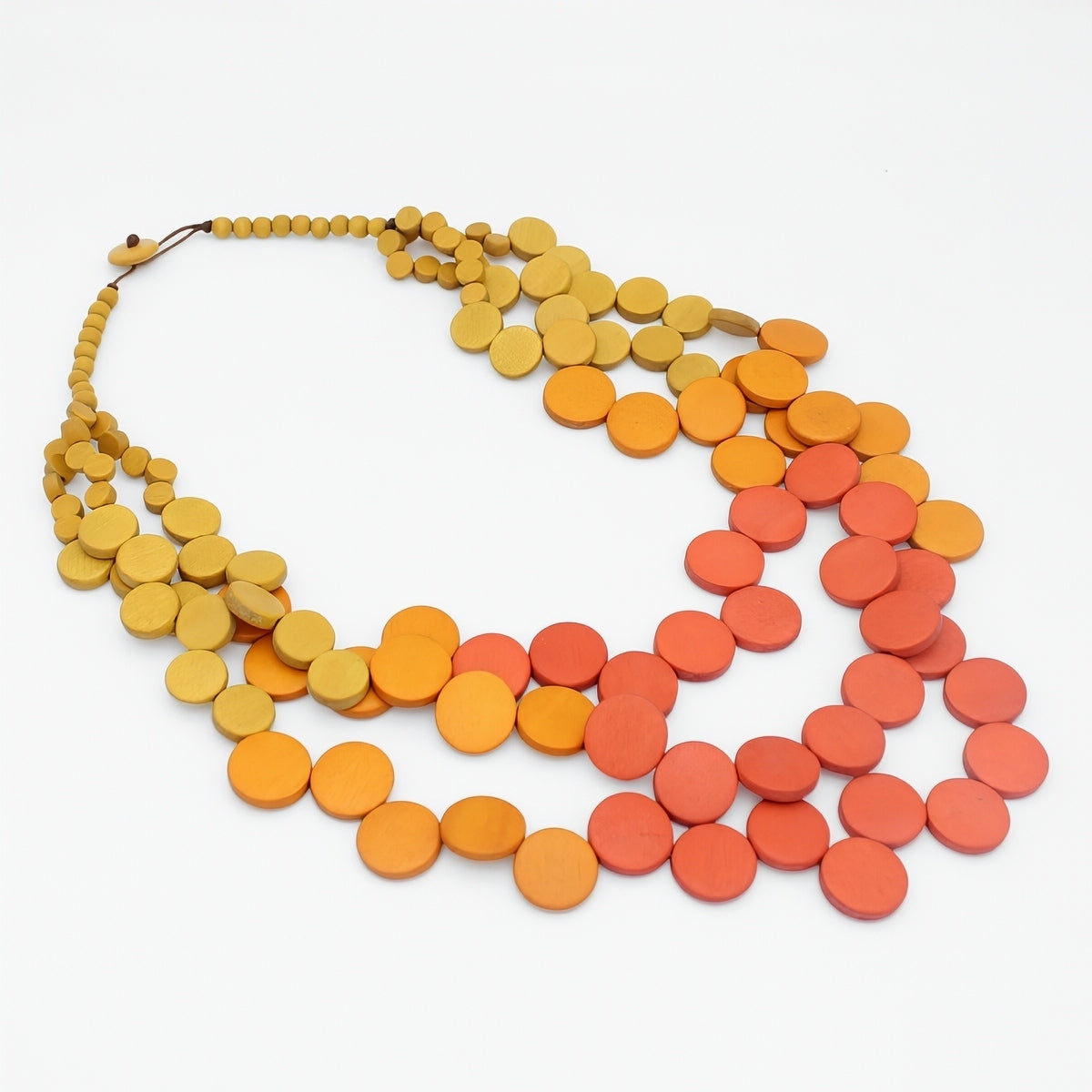 Necklace with orange and red disc beads on a white background