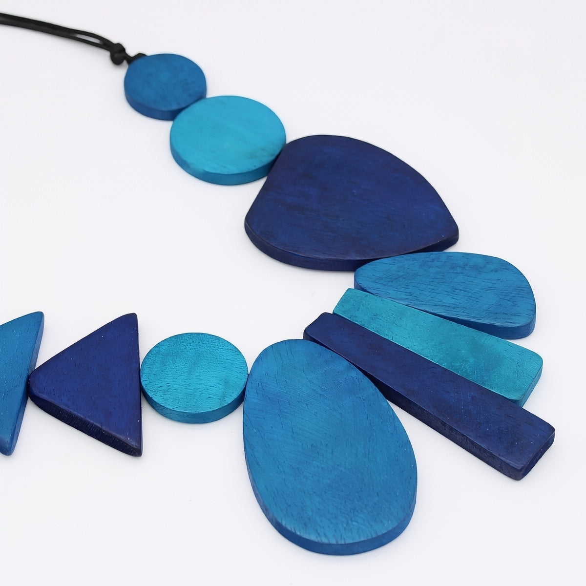 Blue geometric necklace on a white background