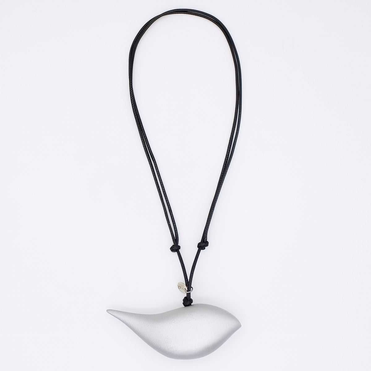 silver bird pendant on a black cord against a white background
