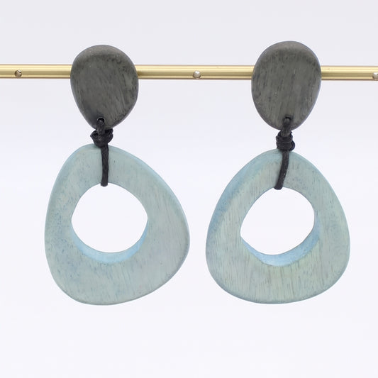 Pair of earrings with light blue circular design on a white background