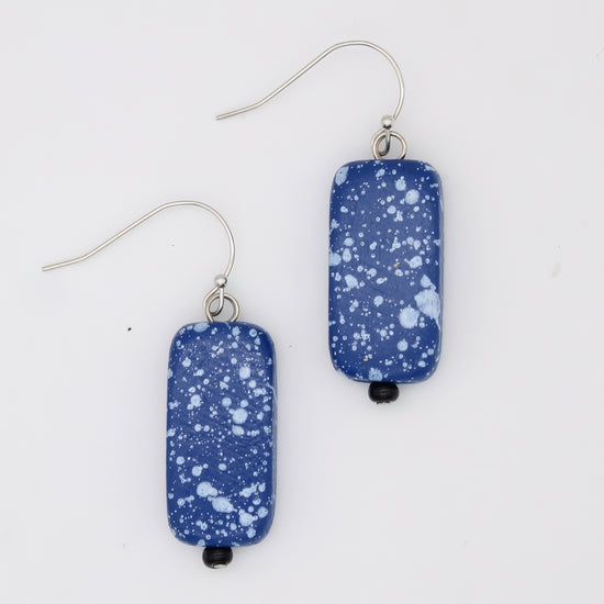 Pair of blue speckled earrings on a white background