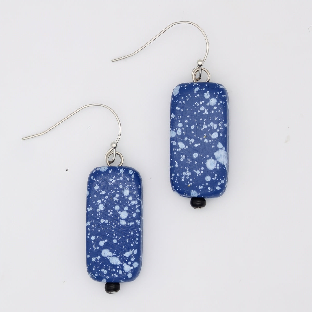 Pair of blue speckled earrings on a white background