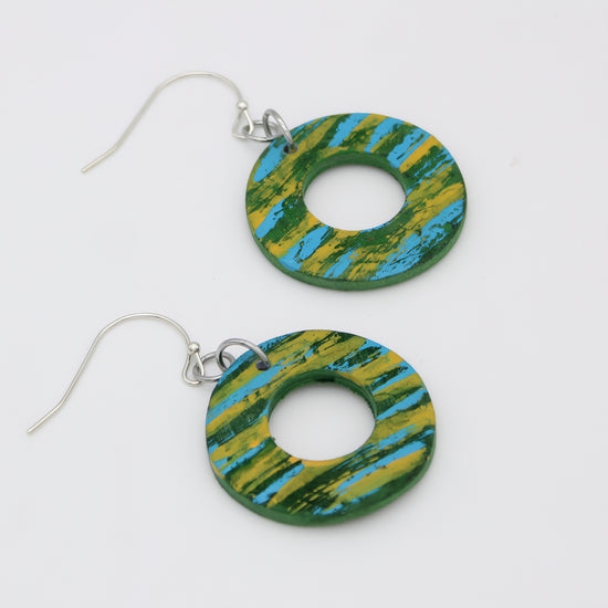 Green and blue striped earrings on a white background