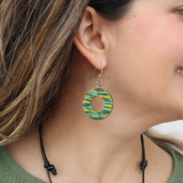 Close-up of a woman wearing a colorful hoop earring.