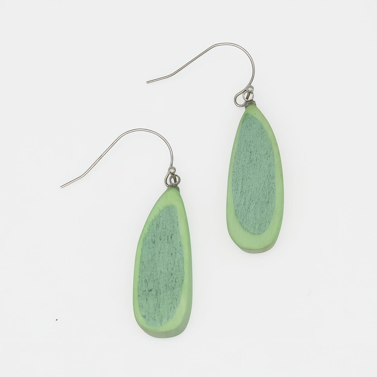 Green teardrop earrings on a white background