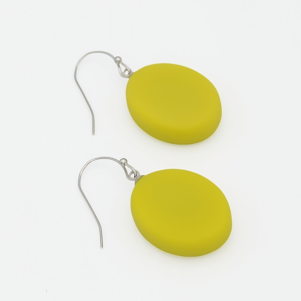 A pair of matte olive-yellow oval drop earrings with silver fishhook wires, displayed on a clean white background.