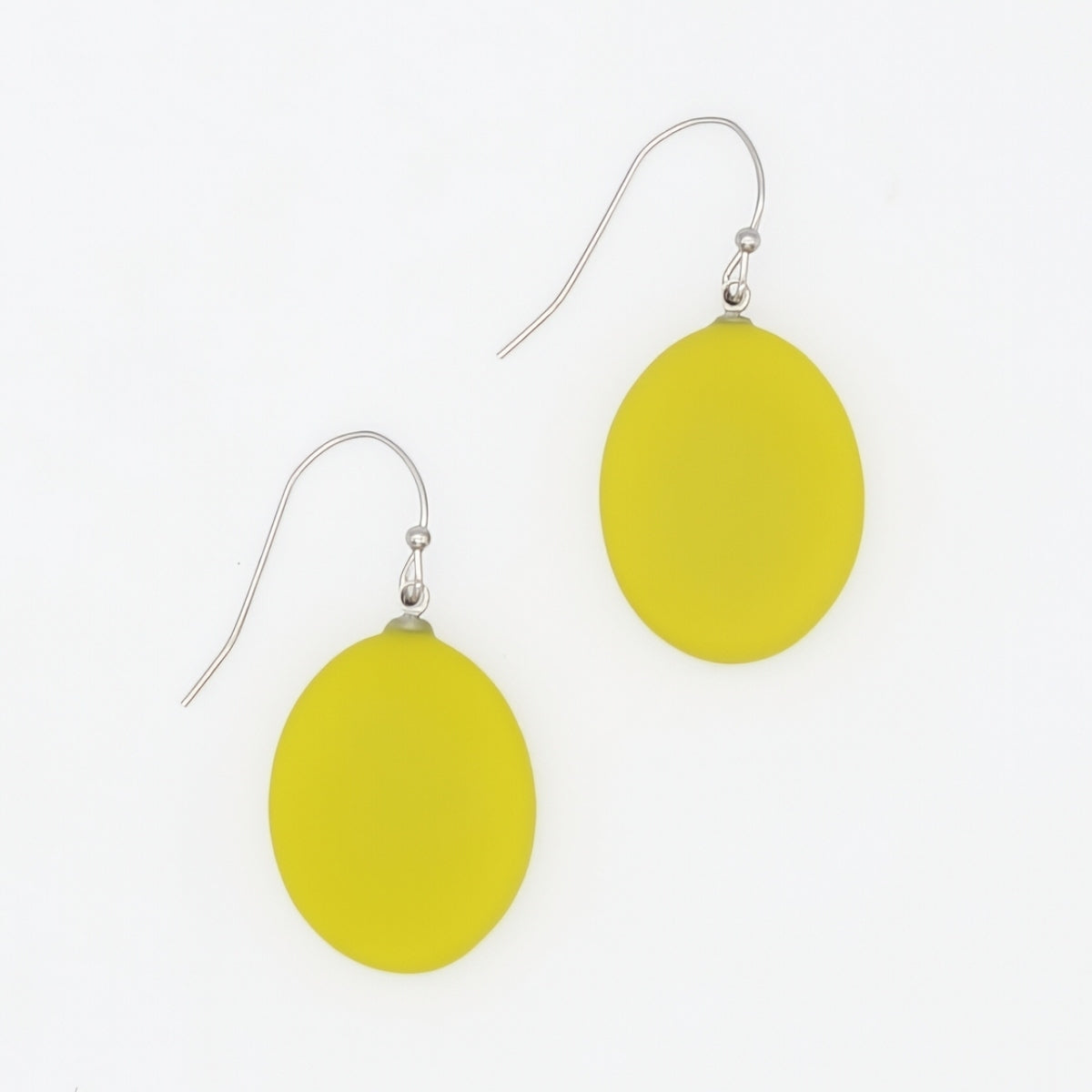 A pair of yellow oval drop earrings with silver fishhook wires, displayed on a clean white background.