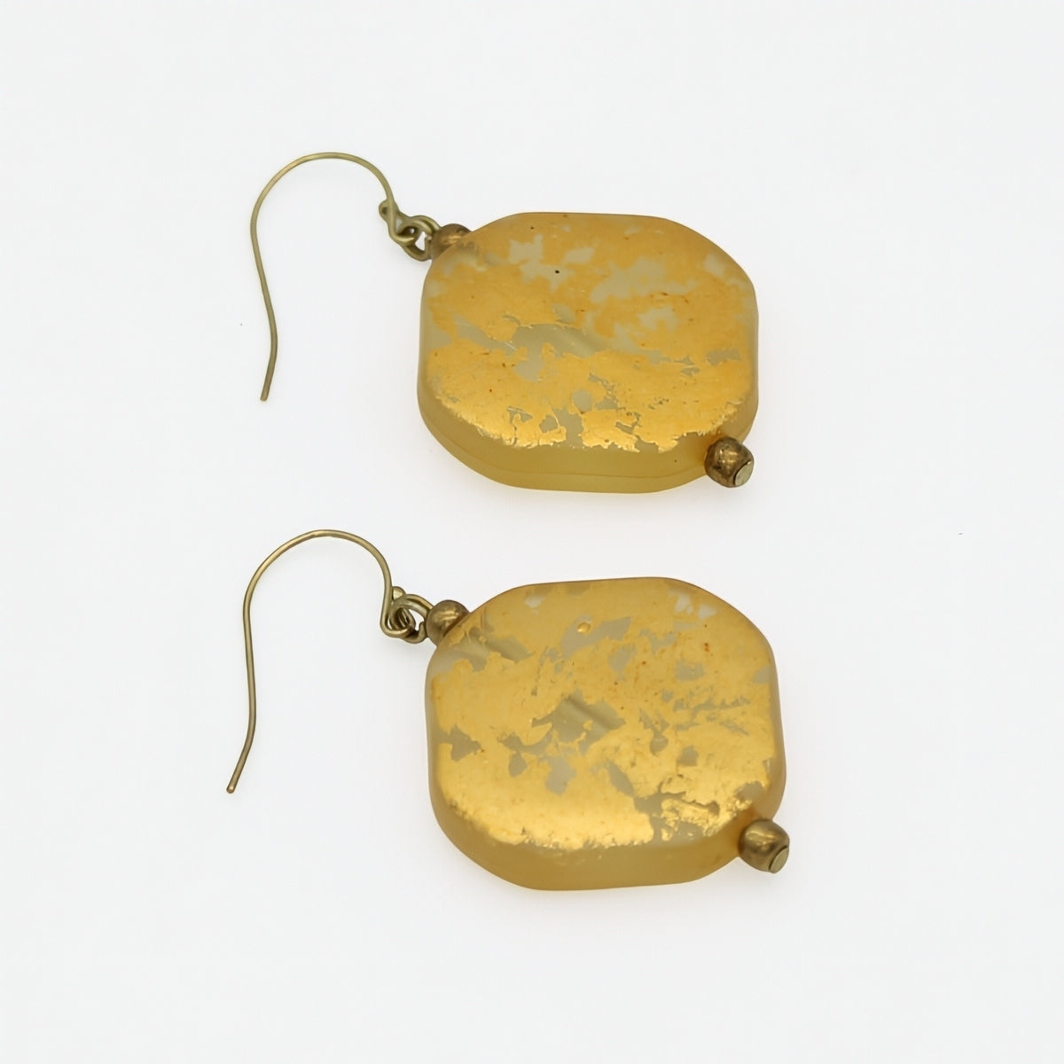 Gold resin drop earrings showing translucent resin and metallic foil, angled view