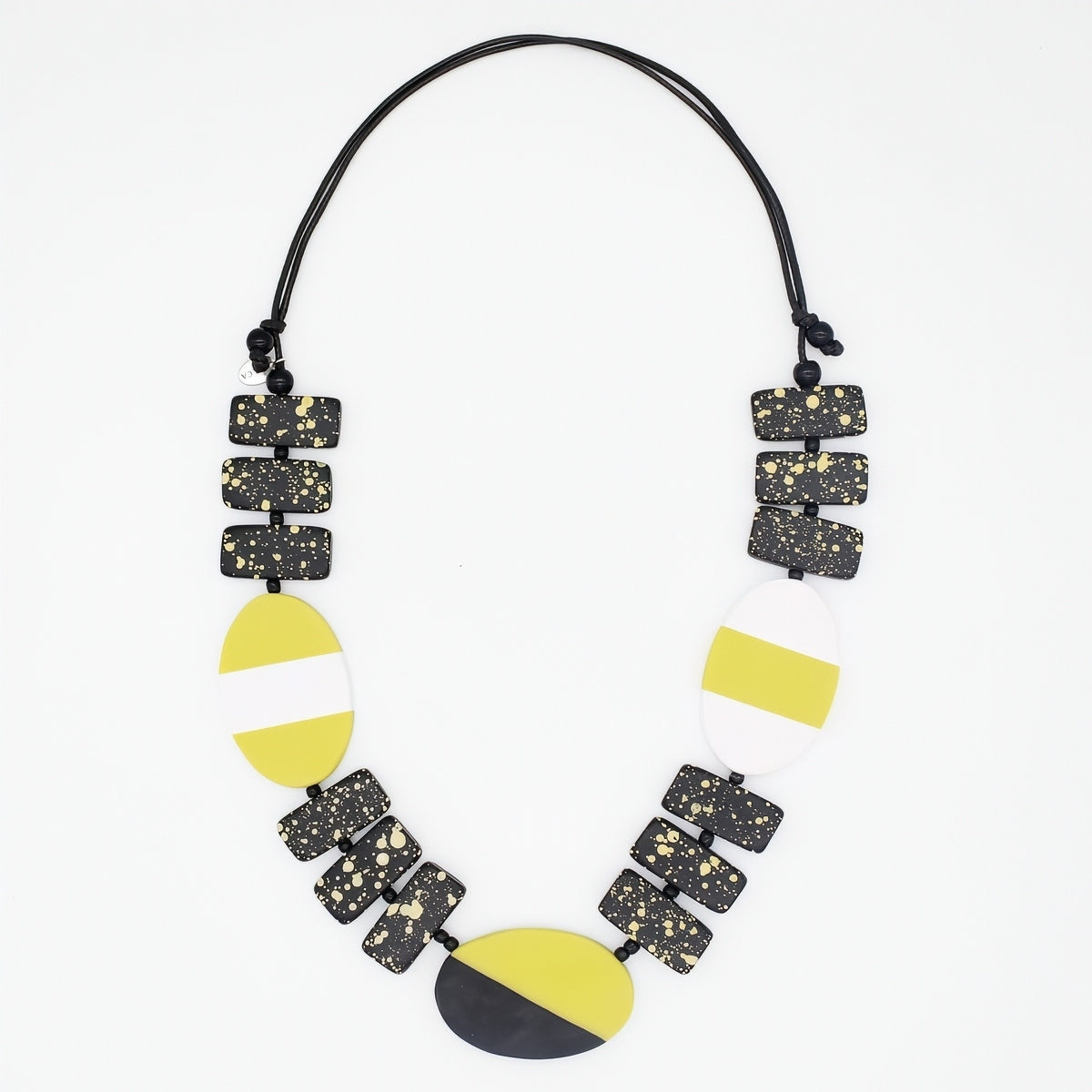 Necklace with geometric black, yellow, and white beads on a white background