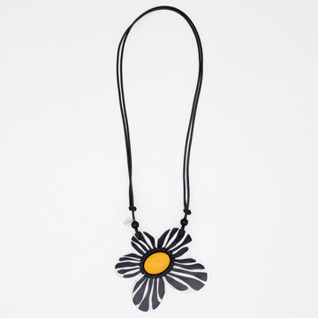 Necklace with a black and yellow flower pendant on a white background