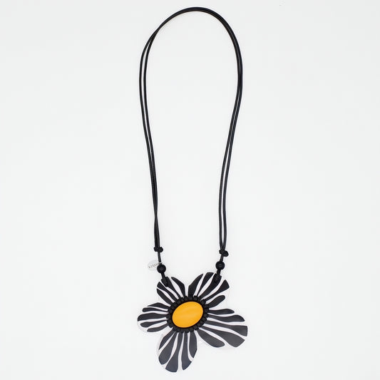 Necklace with a black and yellow flower pendant on a white background
