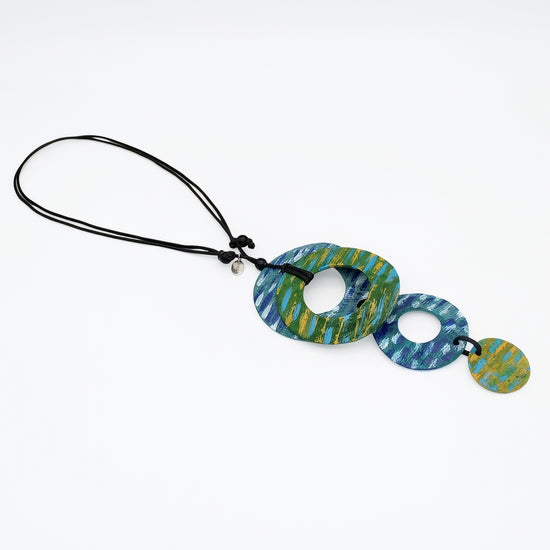 necklace with blue and green circular design on a white background