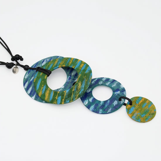 Colorful necklace with circular pendants on a white background