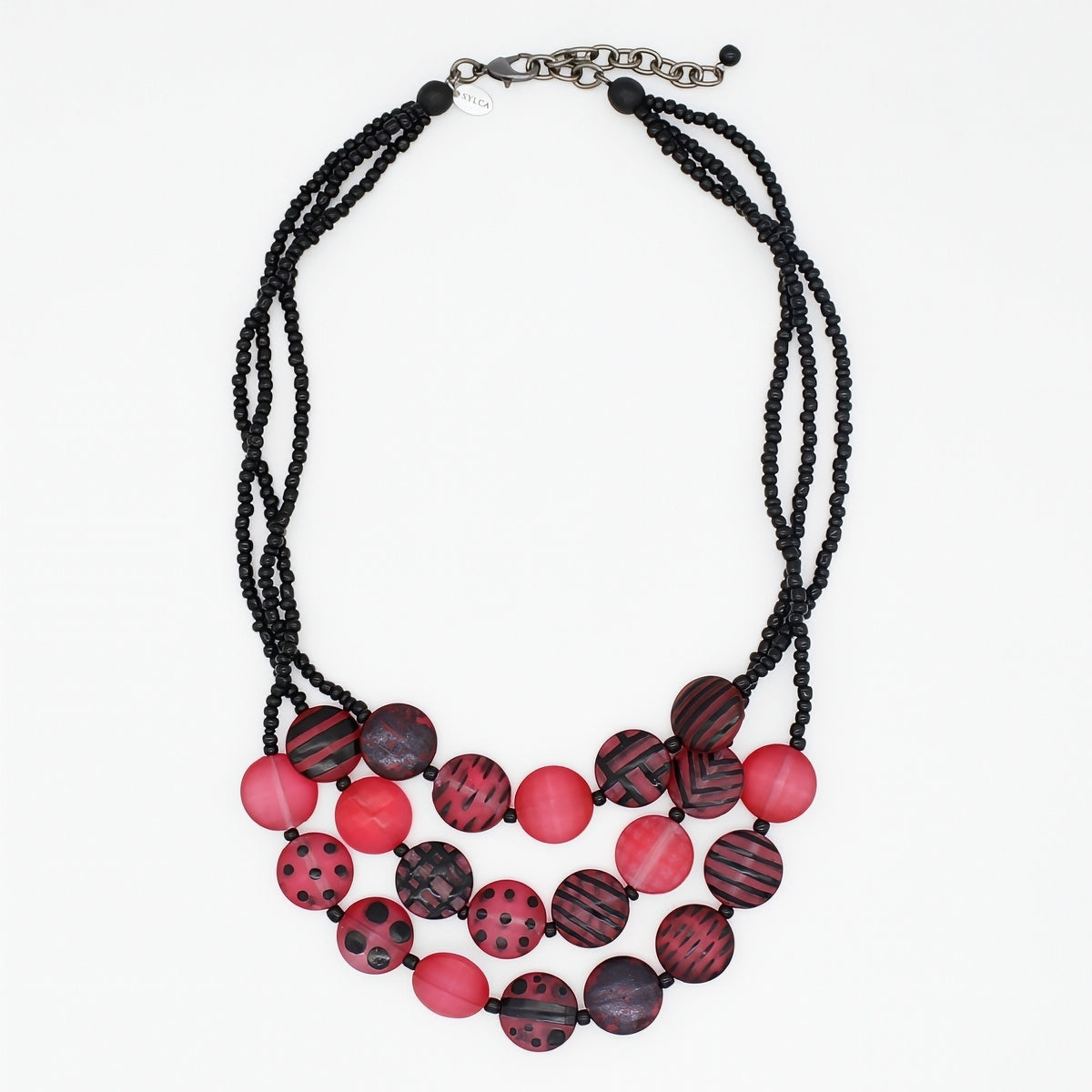 A multi-strand statement necklace featuring black beaded cords and round beads in shades of red, and black patterns, finished with a silver-tone clasp.
