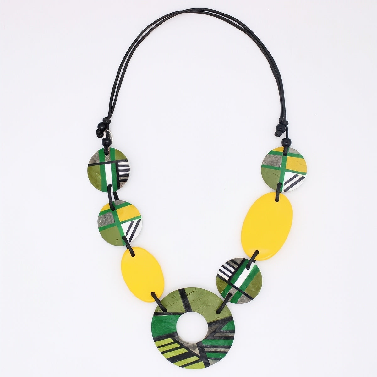 Necklace with green, yellow, and black circular beads on a white background