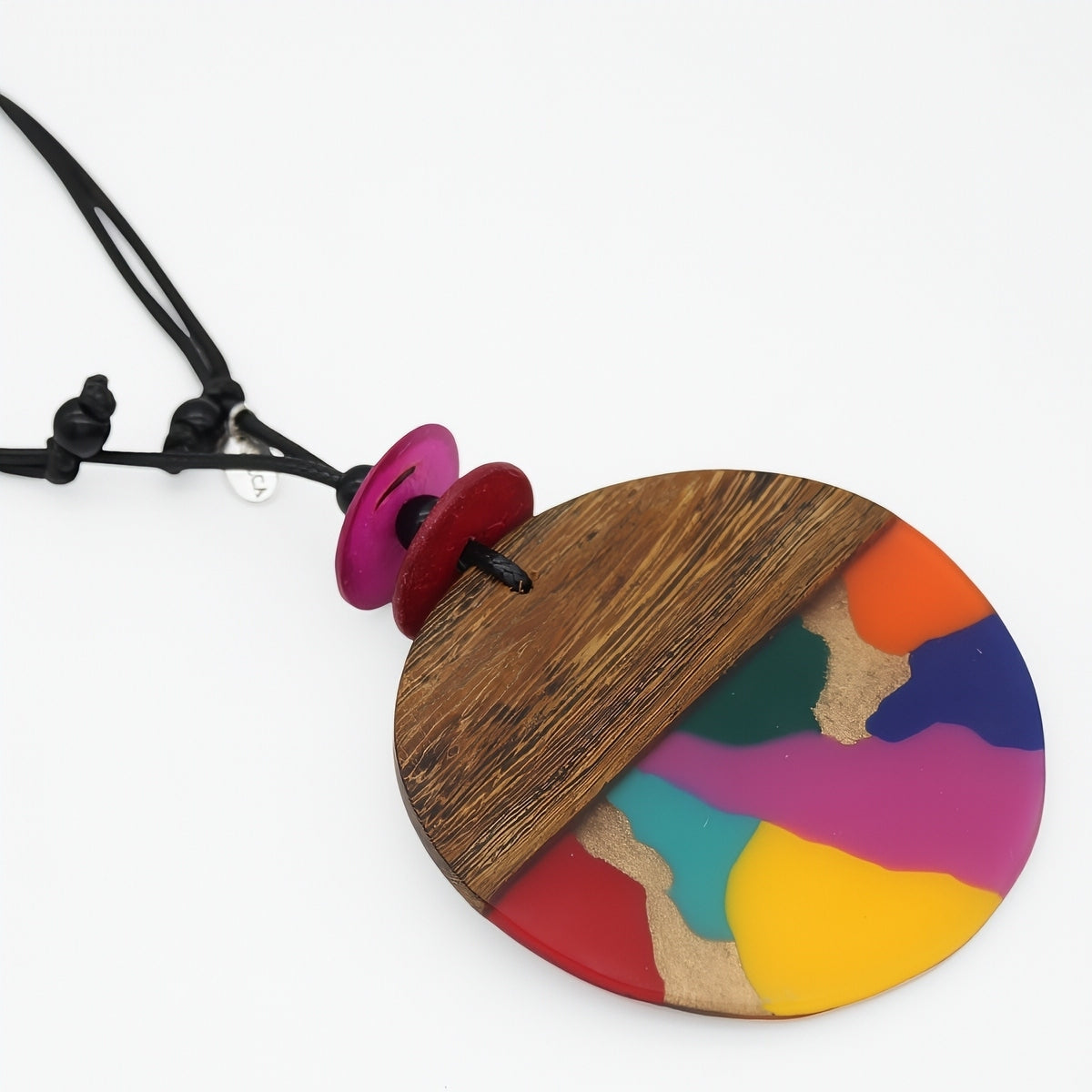 Bold Necklace with a colorful pendant featuring wooden and painted sections on a white background