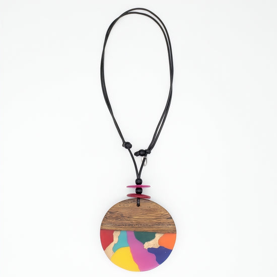 statement Necklace with a round, multicolored pendant on a white background