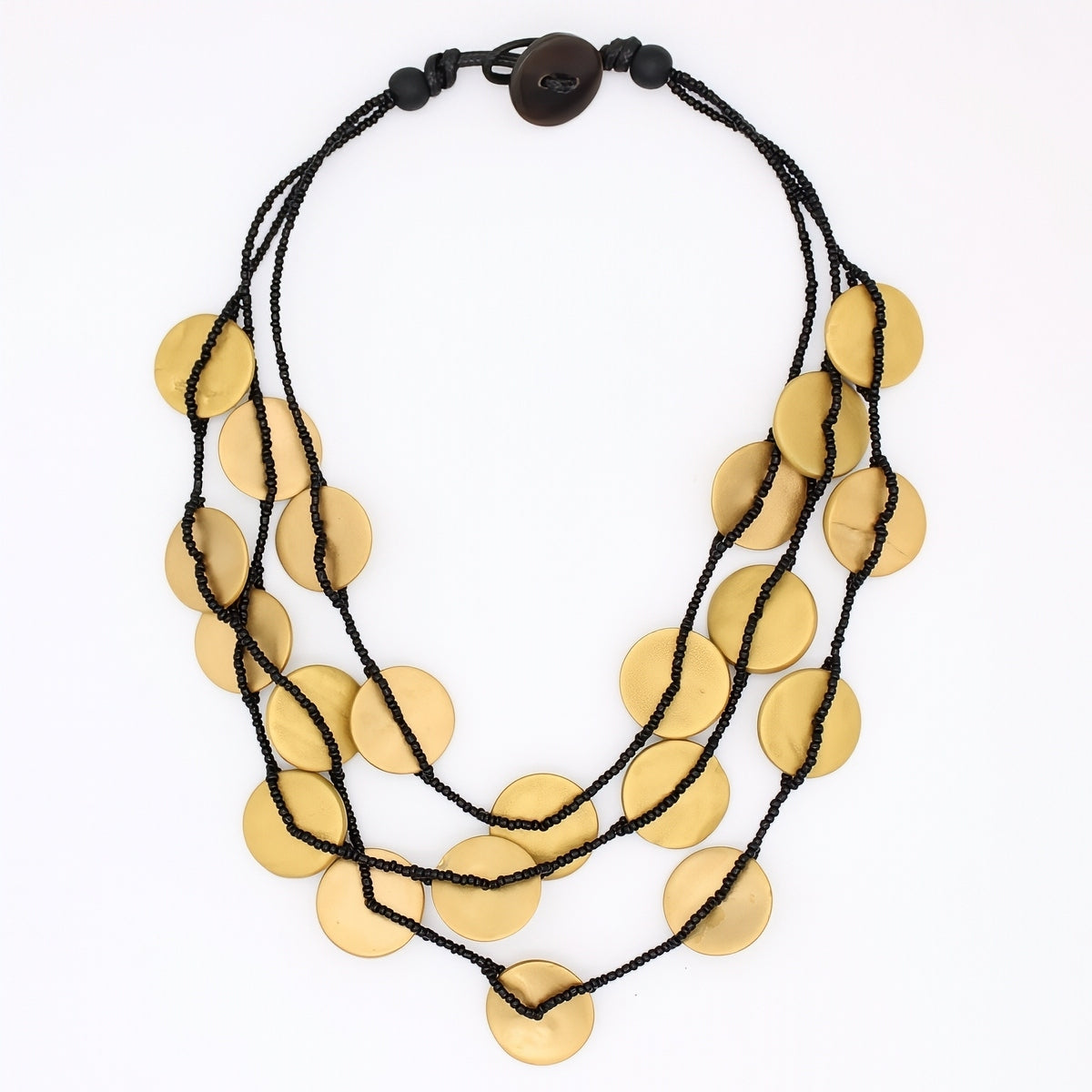 A multi-strand statement necklace featuring multiple flat, circular gold-toned coin-like discs strung on black cords, with a dark brown wooden toggle clasp at the top, shown against a plain white background.