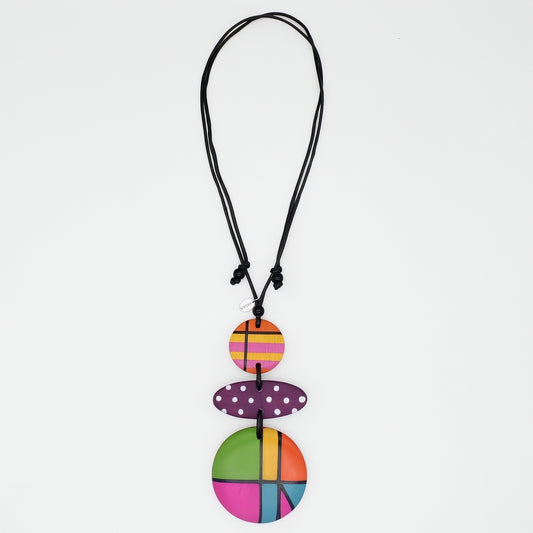 Colorful pendant necklace with a black cord on a white background
