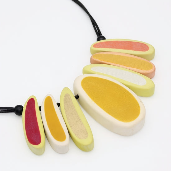 yellow Necklace with colorful, oval-shaped pendants on a white background