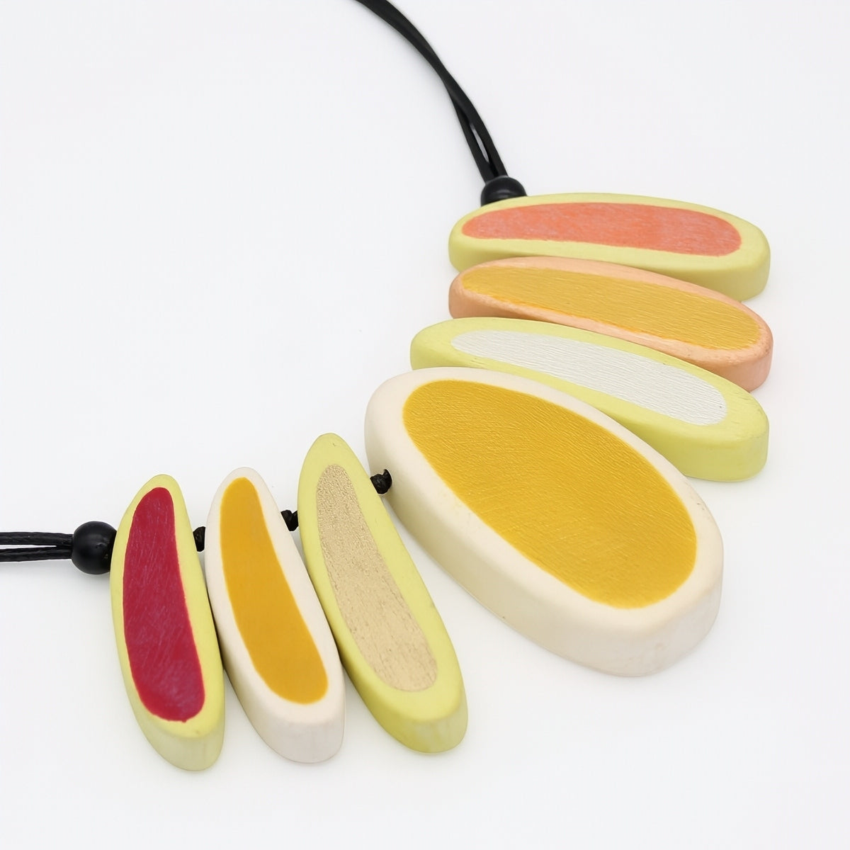 yellow Necklace with colorful, oval-shaped pendants on a white background