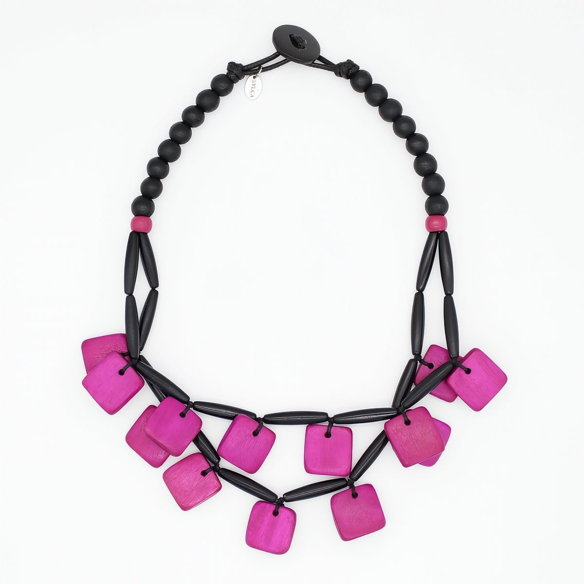 A statement necklace featuring bright magenta-pink square beads and matte black cylindrical beads, arranged in a tiered bib style on a plain white background.