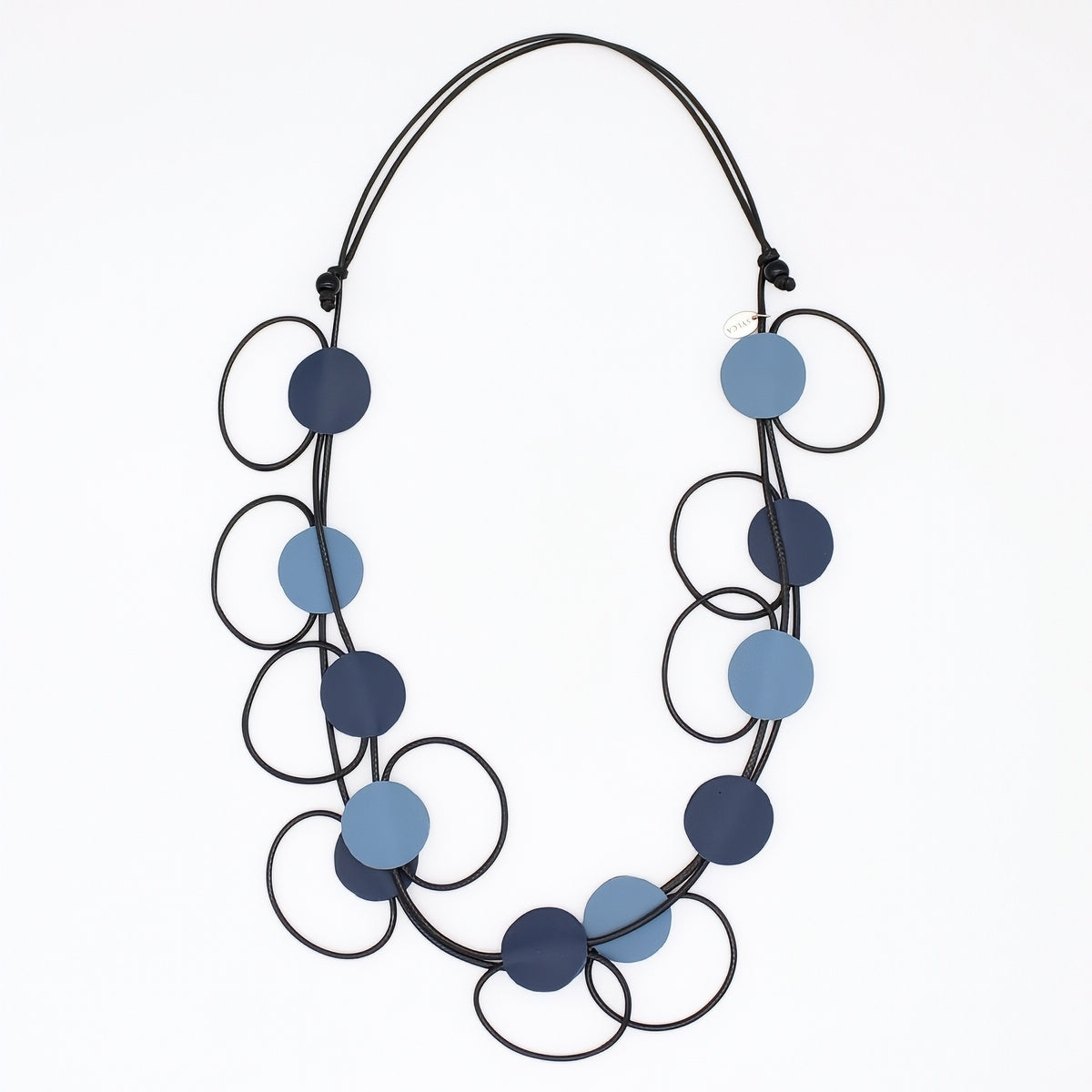 A modern multi-strand necklace featuring matte circular discs in navy and light blue, suspended on a black cord against a plain white background.