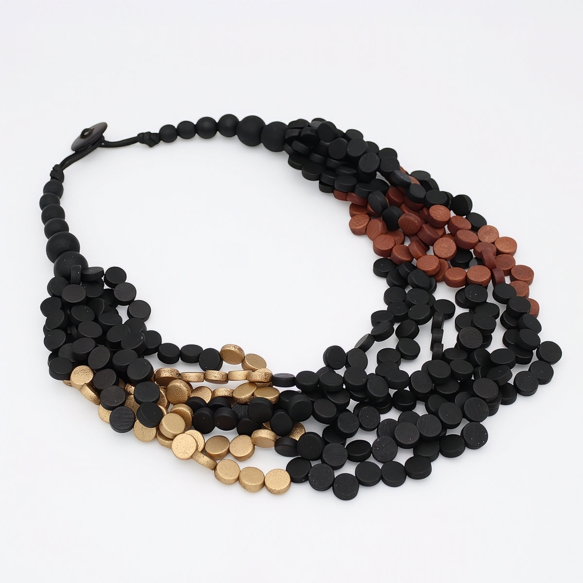 A multi-strand statement necklace made of small round disc beads in black, bronze, and gold, arranged in a loose circle on a white background.