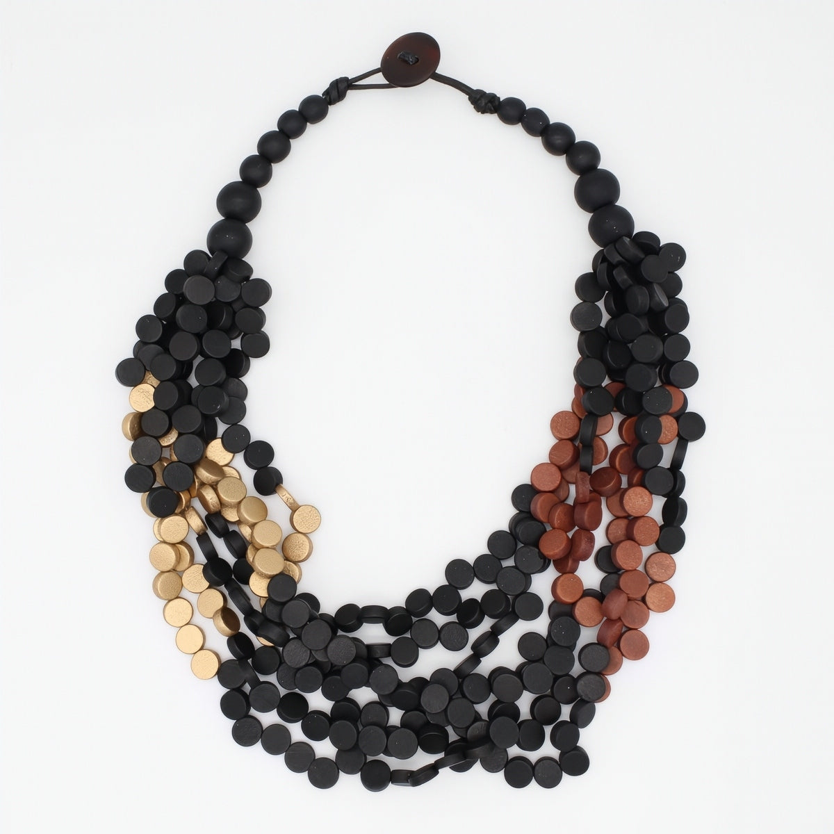 A multi-strand statement necklace featuring matte black, metallic gold, and metallic copper disc beads, arranged in a layered circular style on a plain white background.