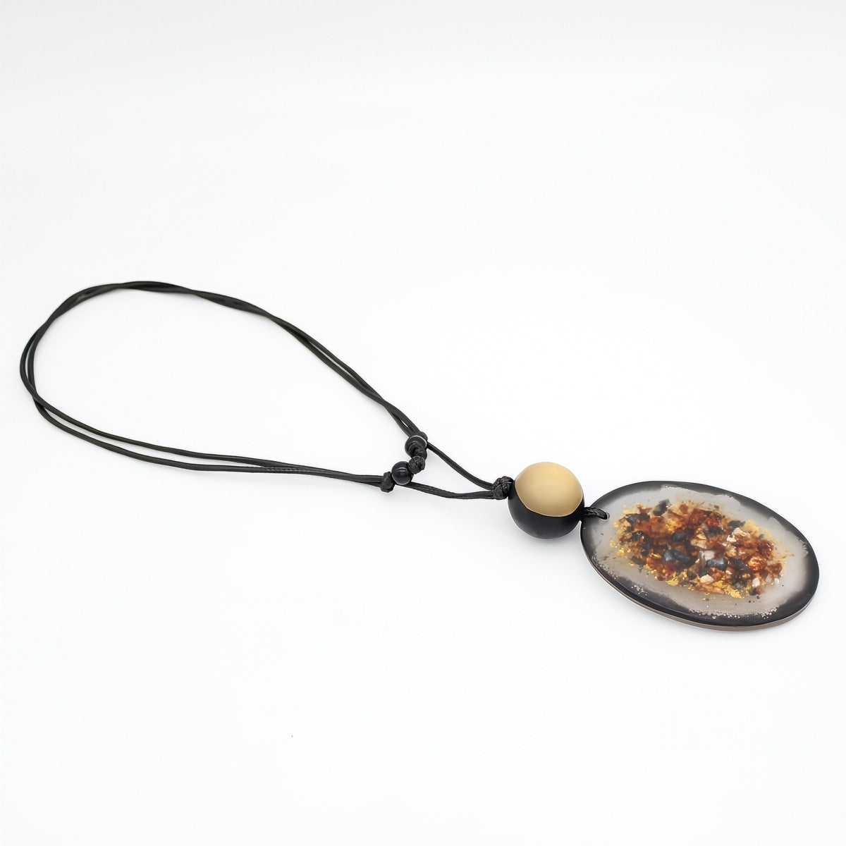 A geode pendant necklace featuring an oval-shaped natural agate slice pendant with a black cord and a small beige wooden bead accent, shown on a plain white background.