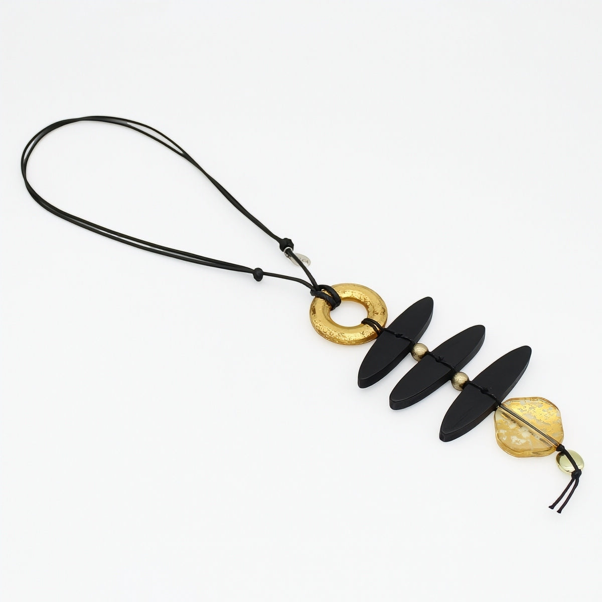 Angled view of black wood and gold resin necklace