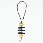Black and gold sculptural statement necklace on adjustable black cord