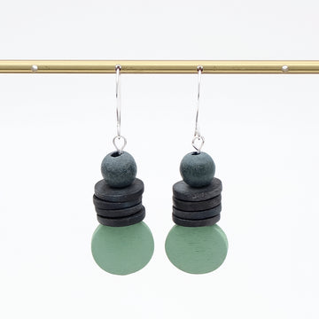 Pair of earrings with stacked circular charms on a white background