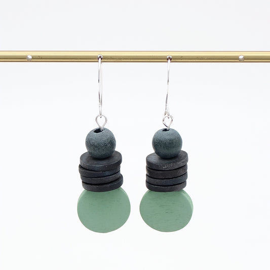 Pair of earrings with stacked circular charms on a white background