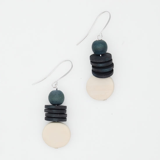 Pair of earrings with stacked black, gray, and white beads on a white background